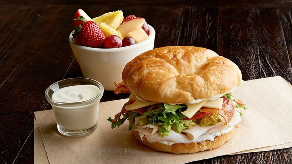 California Club (Manager'S Special) · A half sandwich served with your choice of a cup of soup, fresh fruit or Mac & Cheese. Roasted turkey breast, bacon, Swiss, guacamole, tomato, organic field greens, mayo, on toasted croissant.