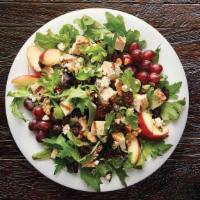 Side Nutty Salad - Family Size · Field greens, grapes, feta cheese, cranberry walnut mix, and organic apples. Served with Bal...