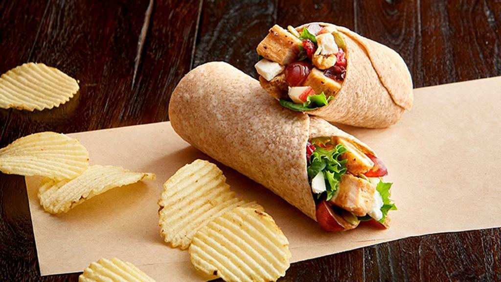 Nutty Mixed-Up Salad Wrap Regular · Grilled, 100% antibiotic-free chicken breast, organic field greens, grapes, feta, cranberry-walnut mix, organic apples, balsamic vinaigrette, in a toasted organic wheat wrap. Served with chips or baked chips (150/100 cal) and a pickle (5 cal).