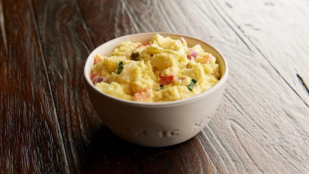 American Potato Salad  · A deli classic featuring baked potatoes, red and green onions, hard-boiled eggs, bell pepper and our own seasoning.