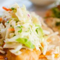 Baja Taco
 · Tempura fried fish topped with Asian slaw, cilantro, and spicy sriracha mayo.