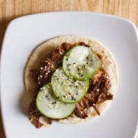 Bbq Short Rib · Short ribs smothered in kogi bbq sauce and topped with cucumber salad.