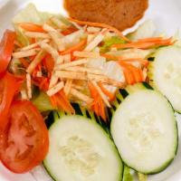 House Salad · Mixed greens, carrots, cucumbers, tomatoes and fried noodles served with choice of peanut or...