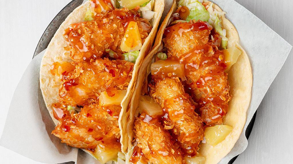 Coconut Shrimp Tiki Taco · Our popular coconut crusted jumbo shrimp is paired with diced pineapple on a bed of tangy coleslaw. Served in two flour tortillas and drizzled with our Sweet Red Chili sauce. Served with chips & salsa. (1130 cal.)