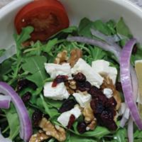 Arugula Salad · Baby arugula mixed with walnuts, tomato and grated Parmesan cheese with olive oil and house ...