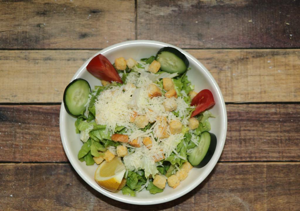 Caesar Salad · Chopped romaine lettuce in Caesar dressing topped with grated Parmesan cheese and croutons.