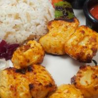 Milton Chicken Kebab · Marinated grilled chicken served with rice and mixed green salad.