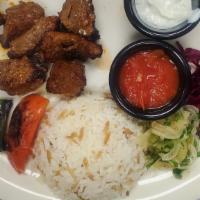 Grilled Lamb Kebab · Marinated grilled lamb served with rice and mixed green salad.
