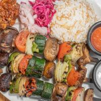 Vegetable Kebab · Marinated chicken thighs grilled to taste. Served with rice and mixed green salad.