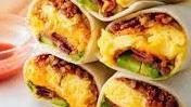 Bacon Breakfast Burrito · Eggs, bacon, tater tots, melted cheese, caramelized onions, avocado.