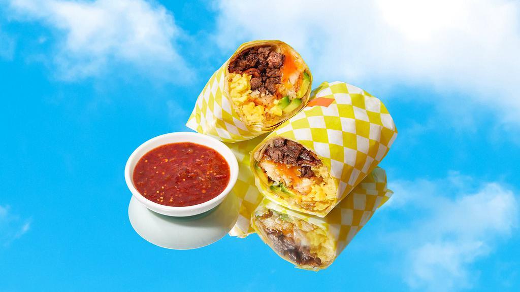 Ultimate Breakfast Burrito · Eggs, carne asada, bacon, tater tots, melted cheese, caramelized onions, avocado.