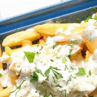 Feta Fries · Seasoned hand cut fries topped with feta a spoon of tzatziki and oregano.