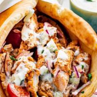 Chicken Gyro · Sliced chicken set on pita bread topped with lettuce, tomatoes, onions and tzatziki sauce.