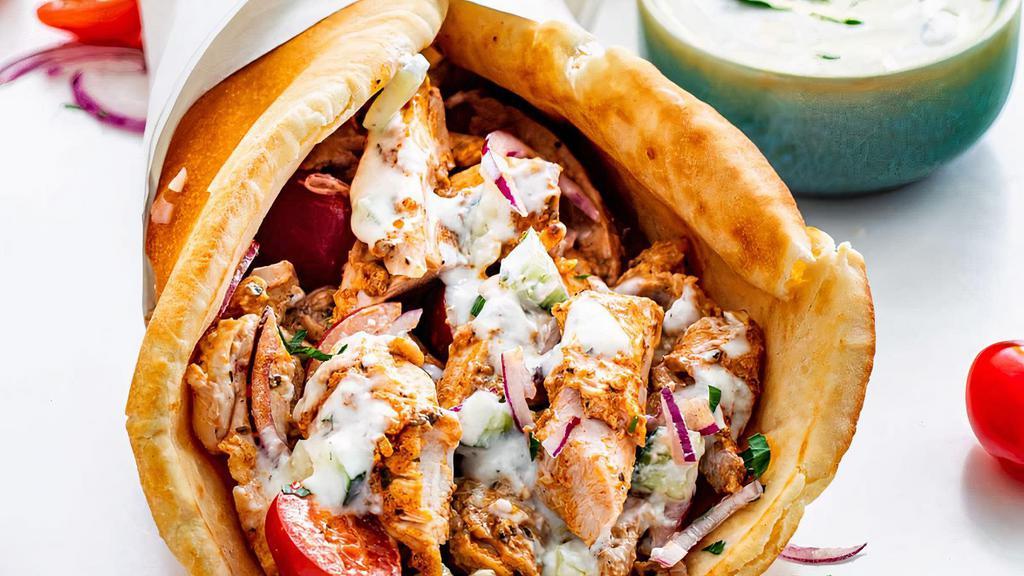 Chicken Gyro · Sliced chicken set on pita bread topped with lettuce, tomatoes, onions and tzatziki sauce.