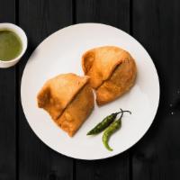 Samosa Classic · Fried pastry with savory-filled spiced potatoes, onions, and peas served with chutneys.