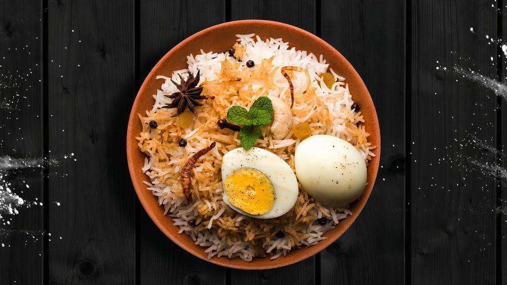 Egg Delight Biryani · Boiled eggs cooked with our signature biryani masala gravy and long grain premium basmati rice. Served with a side of yogurt raita and a spicy salan curry.