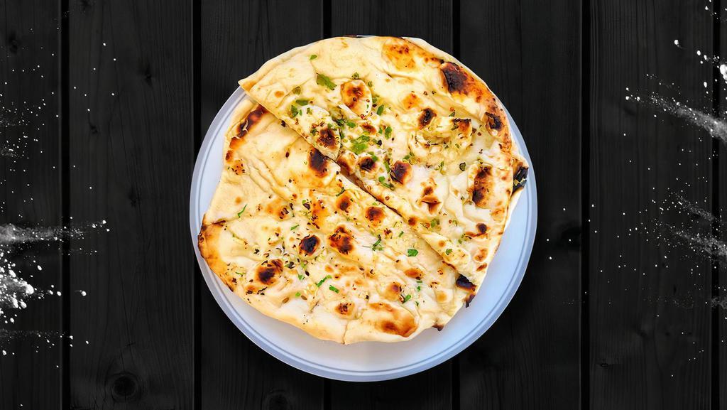 Basic Butter Naan · House-made pulled and leavened dough baked to perfection in an Indian clay oven and basted with generous amounts of butter on both sides.