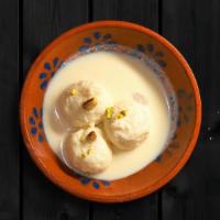 Rasmalai · Two pieces. Soft, small, and spongy flattened balls made by milk dunked in flavored sweet mi...