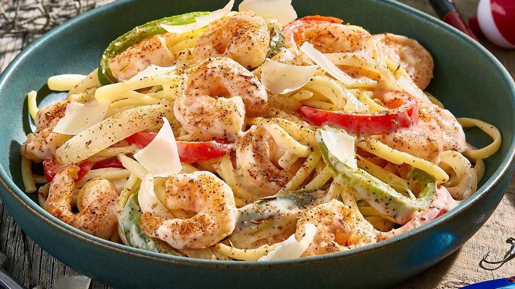 N'Awlins Shrimp Pasta · This little number is a flavor festival. Sauteed shrimp with red and green peppers, onions and tomatoes are tossed in our Cajun Alfredo sauce and served with linguini. And to top it off, there's shaved parmesan cheese.