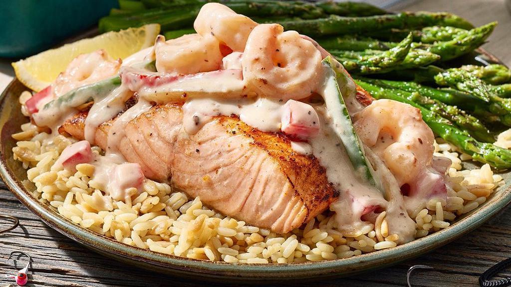 Cajun Kickin' Salmon · A 6-oz. salmon fillet rubbed with some lively Cajun seasoning, topped with a luscious cream sauce made with shrimp, red & green peppers, onions and tomatoes. Served on a bed of rice, with a side of broccoli.