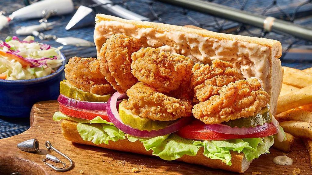 Fried Shrimp Po Boy · Crispy buttermilk fried shrimp with a few dashes of Cajun seasoning and topped with tasty Cajun mayo, lettuce, tomato, onions and pickles on a toasted baguette. Served with crispy fries and coleslaw.