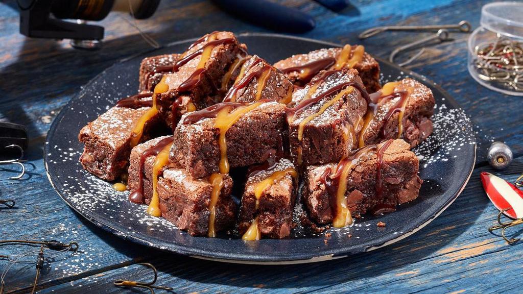 Saucy Brownie Bites · Decadent walnut brownie bites dusted with powdered sugar and served with chocolate and caramel sauces..