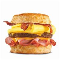 Monster Biscuit® · Crispy bacon, sausage patty, thinly sliced ham, folded egg and two slices of American cheese...