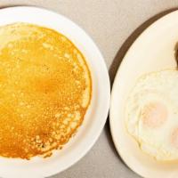 2 Pancake, 2 Eggs · With sausage or bacon and grits.
