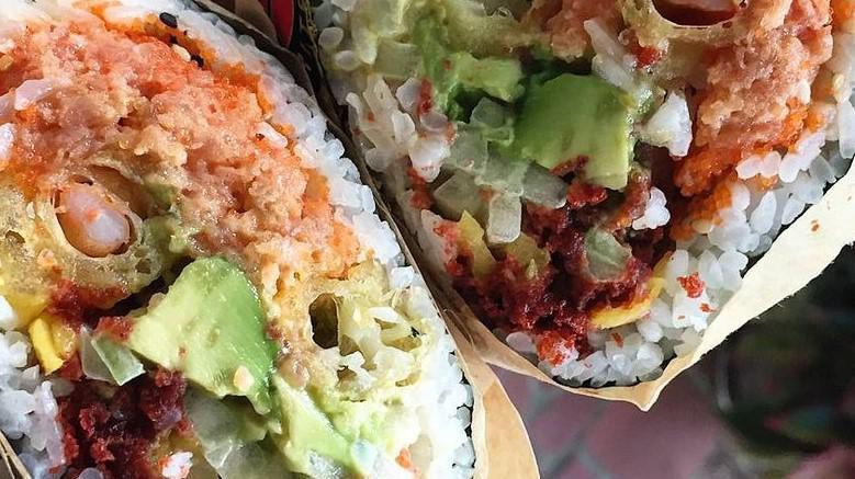 Kazu Sushi Burrito · Spicy tuna, salmon, shrimp tempura, avocado, cucumber, mango, tobiko, tempura flakes, shrimp sauce.