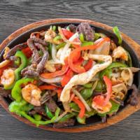 Fajitas Mixta · Grilled steak, chicken, and shrimp grilled with bell peppers, onions, and tomatoes, served w...