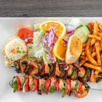 Camarones Brochetas · Grilled shrimp with red and green bell pepper and onions kebab. Served with rice, salad and ...