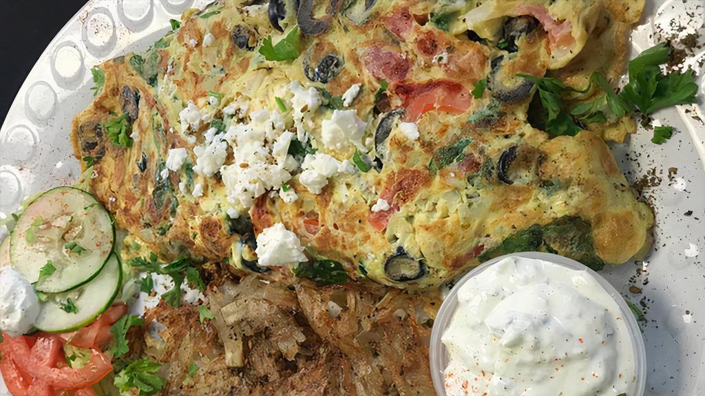 Greek Omelette · Eggs and omelette served with hash browns and pita bread.