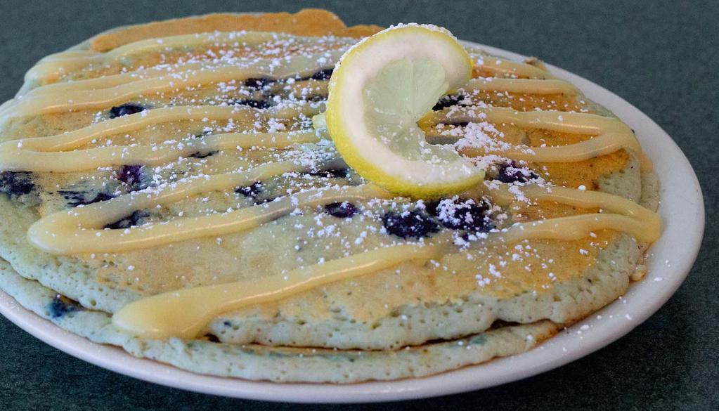 Blueberry Lemon Pancakes  · Two pancakes infused with blueberries and lemon, drizzled with cream cheese icing and  powdered sugar