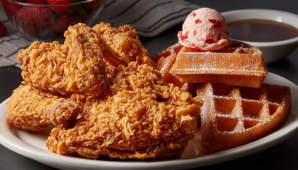 Fried Chicken & Waffle · Half a fried chicken and a Belgian waffle, topped with powdered sugar and sweet, strawberry butter. Served with our signature sweet and spicy sauce.