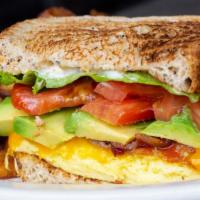 Avocado Breakfast Sandwich · Scrambled eggs, cheddar cheese, bacon and avocado with lettuce, tomato and mayo on eight-gra...