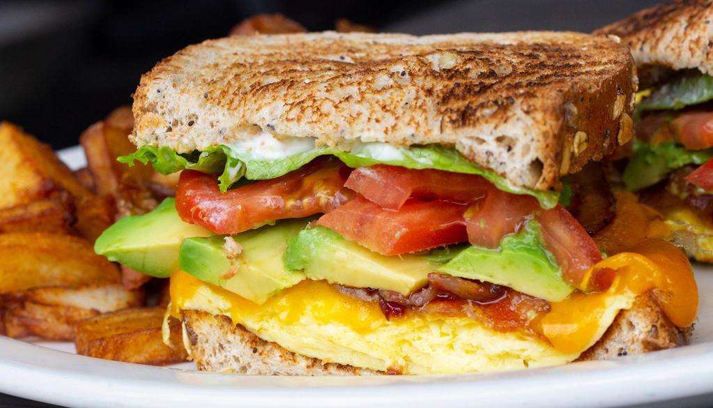 Avocado Breakfast Sandwich · Scrambled eggs, cheddar cheese, bacon and avocado with lettuce, tomato and mayo on eight-grain toast.