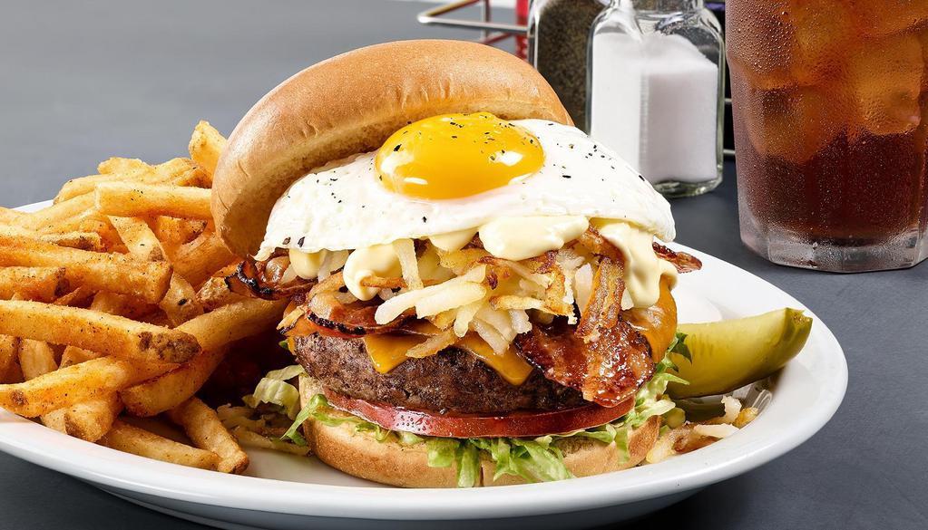 Breakfast Burger · 100% Angus burger, cheddar cheese, hashbrowns, lettuce, tomato, bacon, an egg any style and Hollandaise sauce.