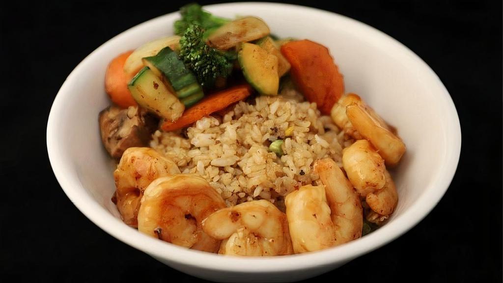 Shrimp Rockin Bowl · Traditional Japanese Fried Rice, Hot Hibachi vegetables, 6 cooked to perfection white shrimp marinated in our house stir fry sauce all served with a side of house made YUM YUM Sauce