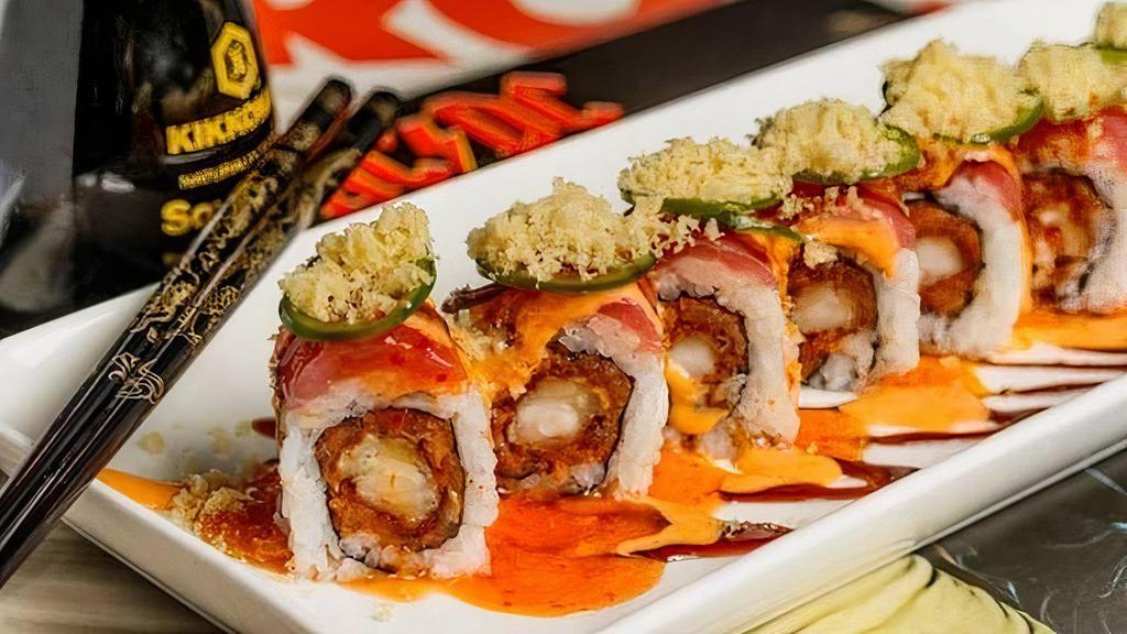 Crowd Surfer Roll · Spice. Sushi. Sauce. Magic. Shrimp tempura and spicy tuna inside, red tuna and jalapeno outside, topped with spicy mayo, eel sauce and crunchy flakes.