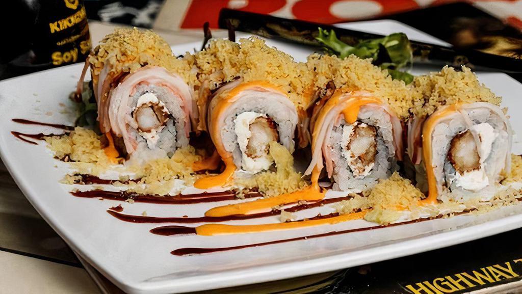 Metalhead · Enter delicious. Shrimp tempura and cream cheese inside, crab stick outside, topped with spicy mayo, eel sauce, and crunchy flakes.