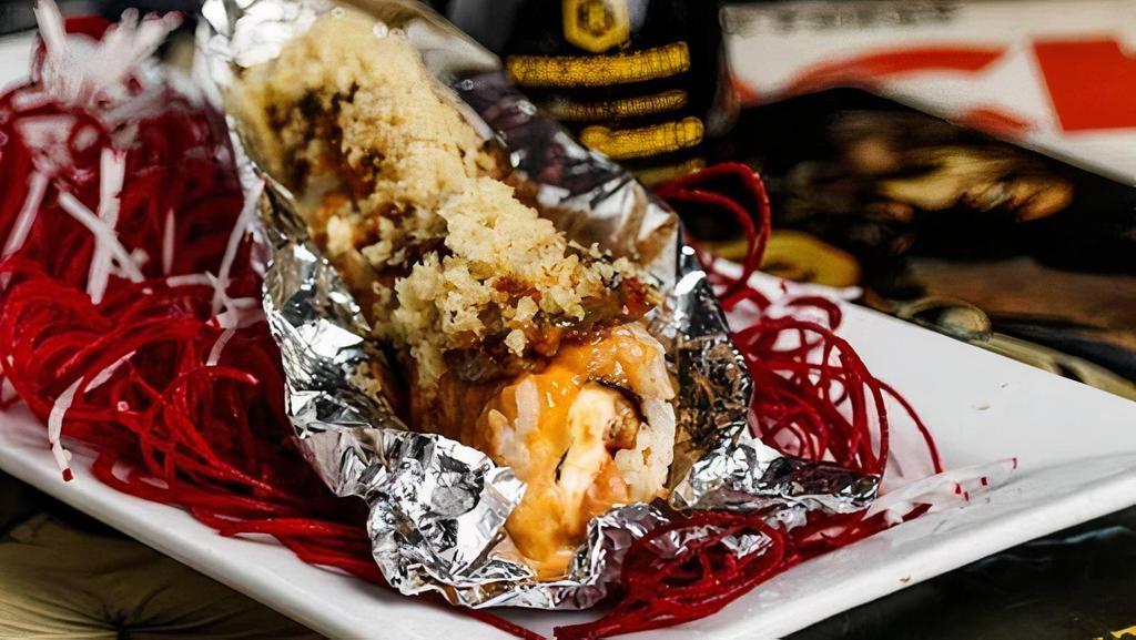 Tourbus · (BAKED) Surf n' turf. Spicy tuna, crab stick, cream cheese inside, topped with seared filet mignon, jalapeno, spicy mayo, sweet chili, eel sauce, sriracha, and crunchy flakes.  Spicy.