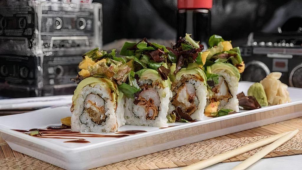 Legends Roll · Light fare meets heavy metal.  Soft shell crab tempura and crab stick inside, avocado outside, topped with mango jalapeno spring mix salad in a sweet chili dressing and drizzled with eel sauce.