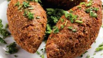 Kibbi (Serves Three) · Ground sirloin mixed with cracked wheat stuffed with beef, onion, and pine nuts.