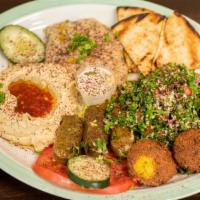 Falafel Platter · Falafel, hummus, baba ganough, salad, and tahini sauce.