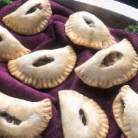 Ratatouille Empanada · Vegan. Onions, tomatoes, green and red peppers, zucchini, and eggplant.