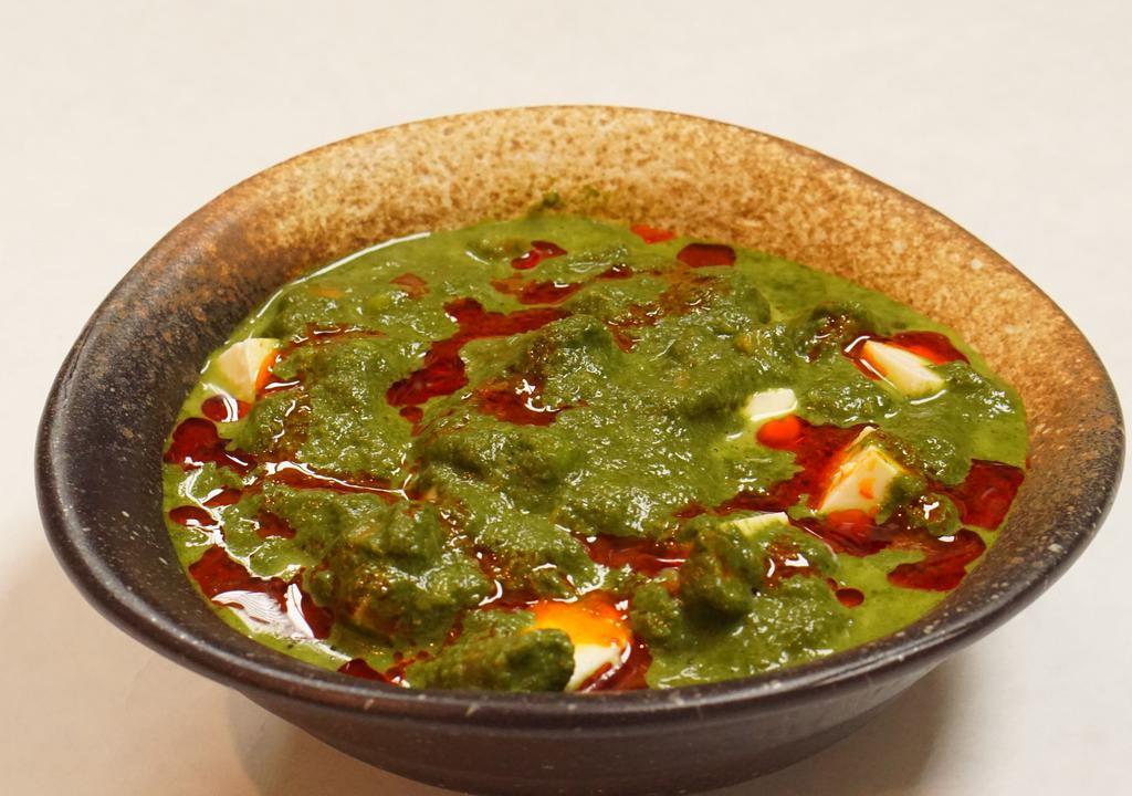 Saag Paneer · Gluten free, vegetarian. Spinach puree, cubed paneer, onion, tomato, and cream. Served with white rice.