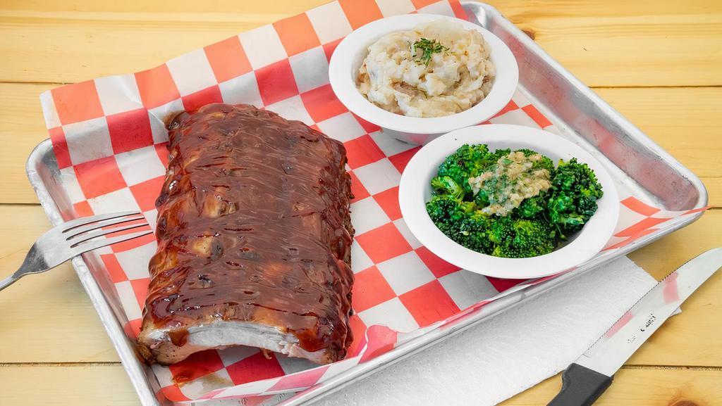 Bbq Baby Back Ribs · Slow roasted, tender to the bone, basted in sweet & tangy BBQ sauce. Half Rack. Served with your choice of two sides: Chips, Crinkle Fries, Mashed Potatoes, Coleslaw, or Vegetable(s) of the Day.