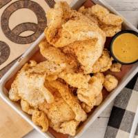 Pork Rinds · Crispy pork rinds made in house with a smoked honey mustard sauce for dipping.