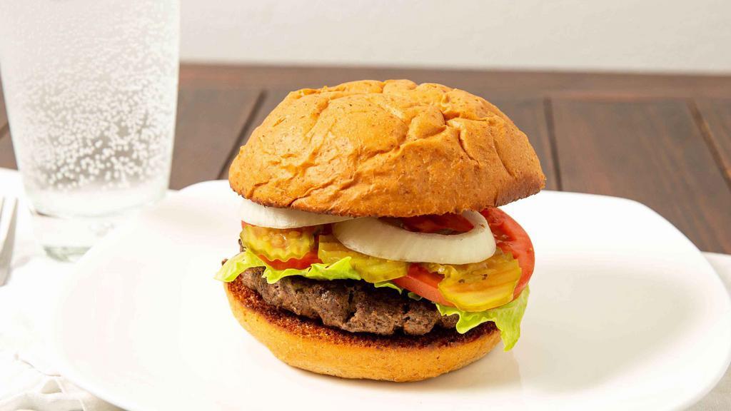 American Kobe Burger · Antibiotic-free, hormone-free, pasture-raised, 100% all-natural.  Served with lettuce, tomatoes, onion and pickles on the side.