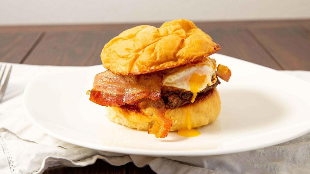 Hangover Burger · 100% all-American premium cut 1/2 pound beef burger. Topped with smokehouse bacon, cheddar cheese, and a fried egg. (item includes lettuce, tomato, and onion on the side.)